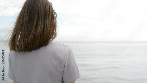 Young woman is looking into the distance.