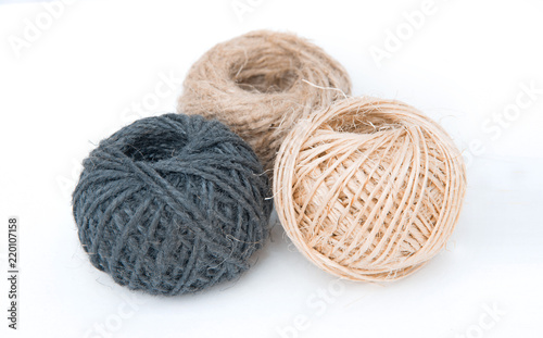  Three tangle of colored thread for knitting on a white background