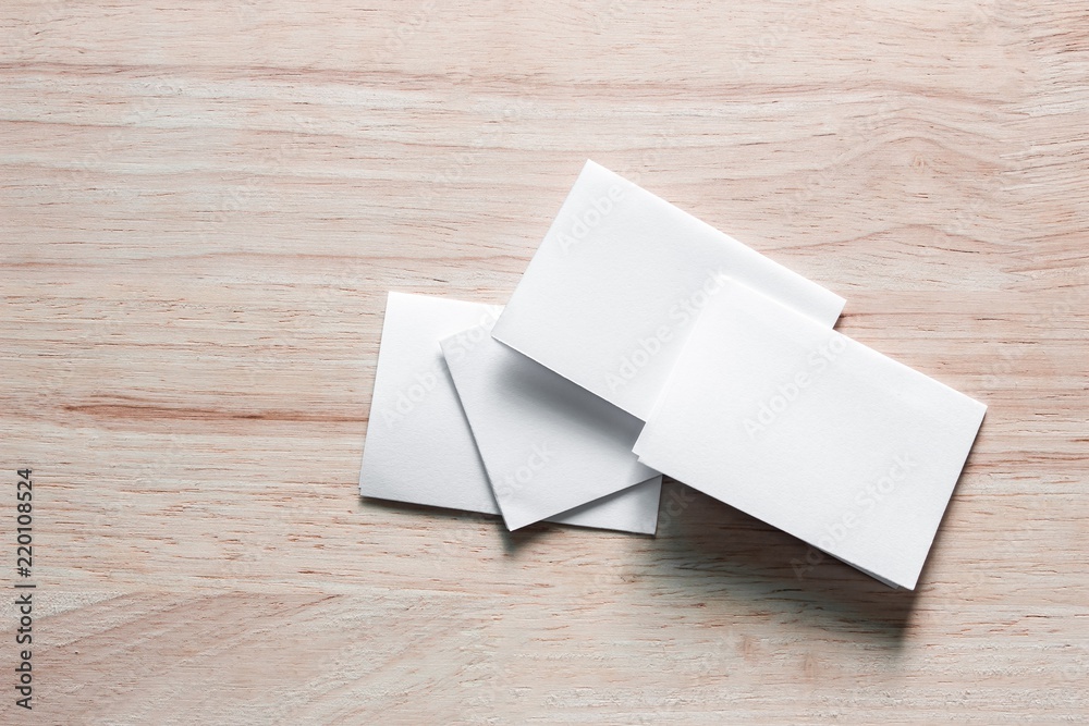 Blank portrait mock-up paper. brochure magazine isolated on brown wooden table, changeable background / white paper isolated on wood Blank portrait mock-up paper. brochure magazine isolated on brown wooden table, changeable background / white paper isolated on wood