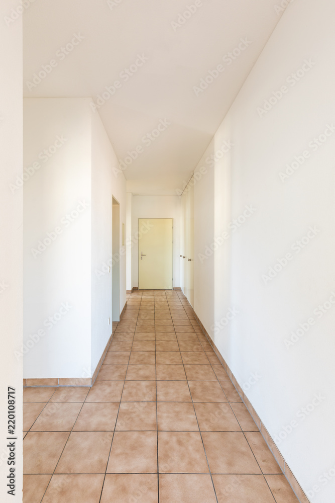 Fototapeta premium White corridor with tiles and closed doors