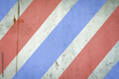 Concrete wall in red and blue stripes. Background for Barber Shop. Background.