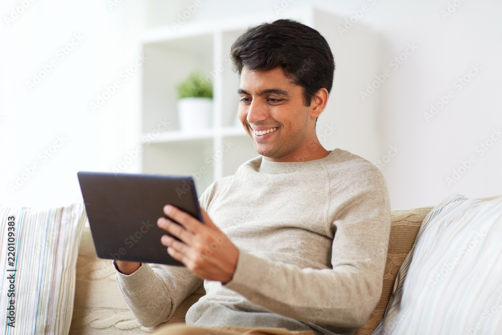 technology, people and lifestyle concept - happy man with tablet pc computer at home technology, people and lifestyle concept - happy man with tablet pc computer at home