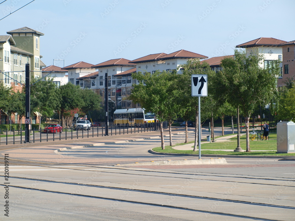 A light rail line winds its way eastward around Lake Carolyn at Las COlinas on its way from Terminal A at the big airport. 