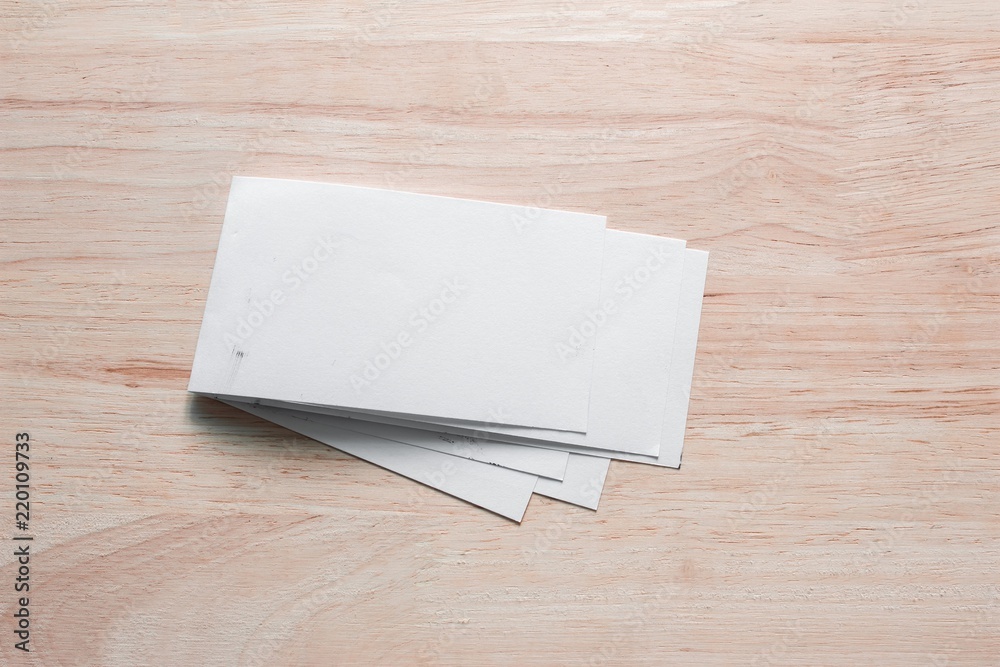 Blank portrait mock-up paper. brochure magazine isolated on brown wooden table, changeable background / white paper isolated on wood Blank portrait mock-up paper. brochure magazine isolated on brown wooden table, changeable background / white paper isolated on wood