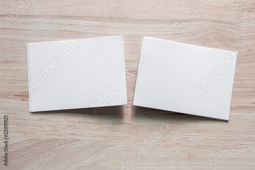 Blank portrait mock-up paper. brochure magazine isolated on brown wooden table, changeable background / white paper isolated on wood