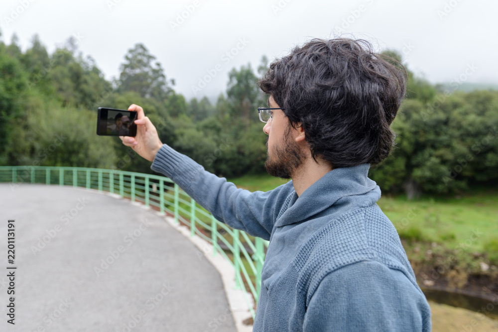 a man with a beard makes a selfie a man with a beard makes a selfie