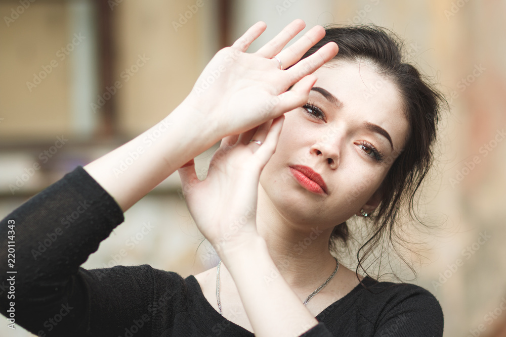 Fototapeta premium Happy girl closes her hands from the sun