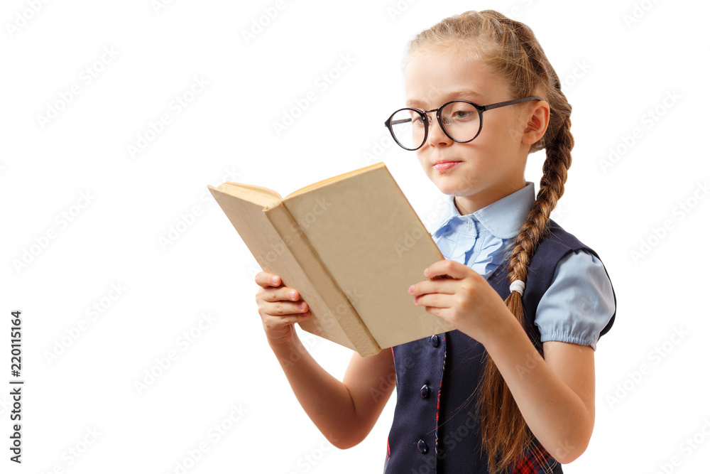 Cute little girl reads a book while wearing glasses, isolated on white Cute little girl reads a book while wearing glasses, isolated on white