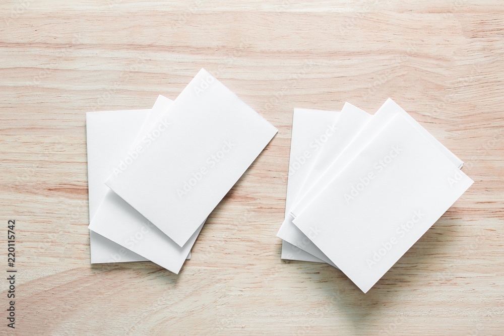 Blank portrait mock-up paper. brochure magazine isolated on brown wooden table, changeable background / white paper isolated on wood Blank portrait mock-up paper. brochure magazine isolated on brown wooden table, changeable background / white paper isolated on wood