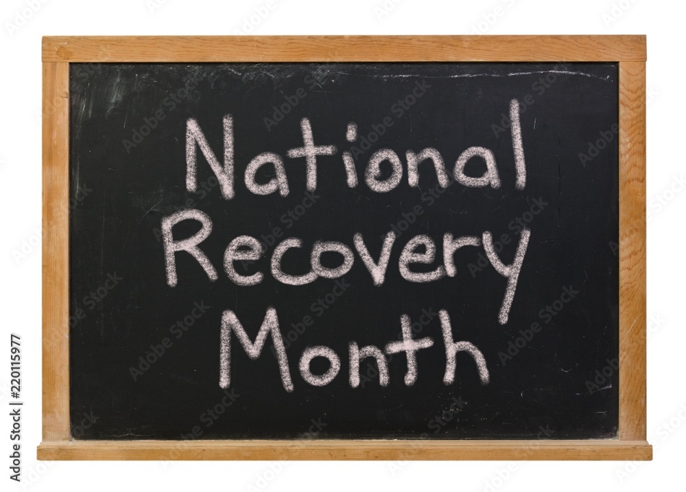 National Recovery Month written in white chalk on a black chalkboard isolated on white National Recovery Month written in white chalk on a black chalkboard isolated on white