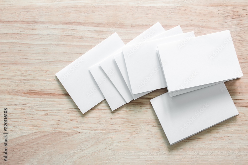 Blank portrait mock-up paper. brochure magazine isolated on brown wooden table, changeable background / white paper isolated on wood Blank portrait mock-up paper. brochure magazine isolated on brown wooden table, changeable background / white paper isolated on wood