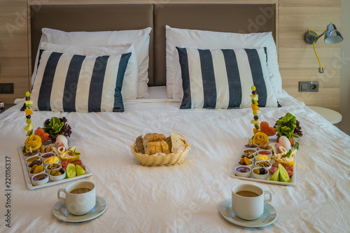 Breakfast in bed, Turkish brekafast with juice and coffee in bed of an hotel room photo