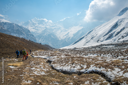 Tourist walking back from Annapurna base camp to foothills with the beautiful Machapuchare (Mt.Fish tail) mountain, Nepal.
 photo