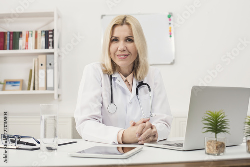 Portrait of female doctor sitting at desktop