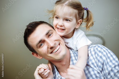 Happy loving family. Father and his daughter child girl playing and hugging. Shallow depth of field.