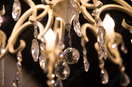 Chrystal chandelier close-up in the dark. Glamour background
