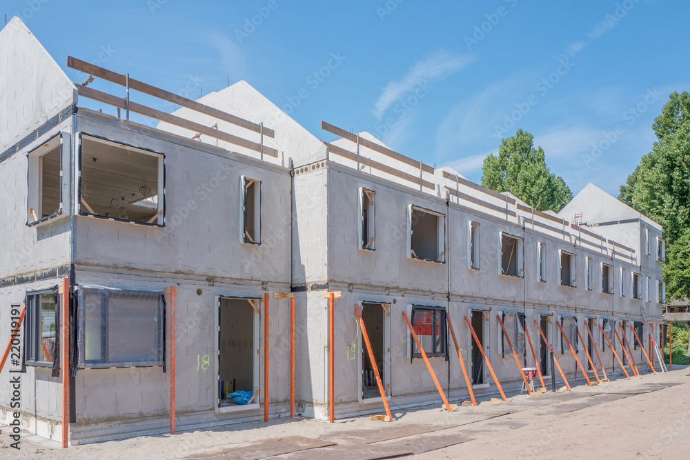 Building site with rows of houses under construction. Building site with rows of houses under construction.