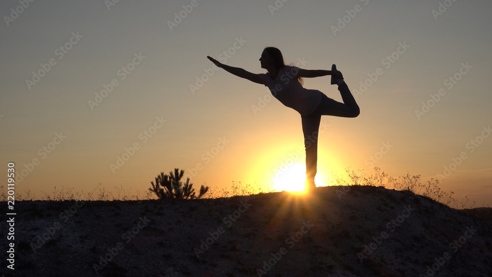 Silhouette young woman practicing yoga and Meditation at sunset