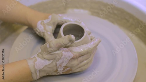 Potter's wheel. The process of making pottery in a pottery workshop. Dishes made of clay. photo