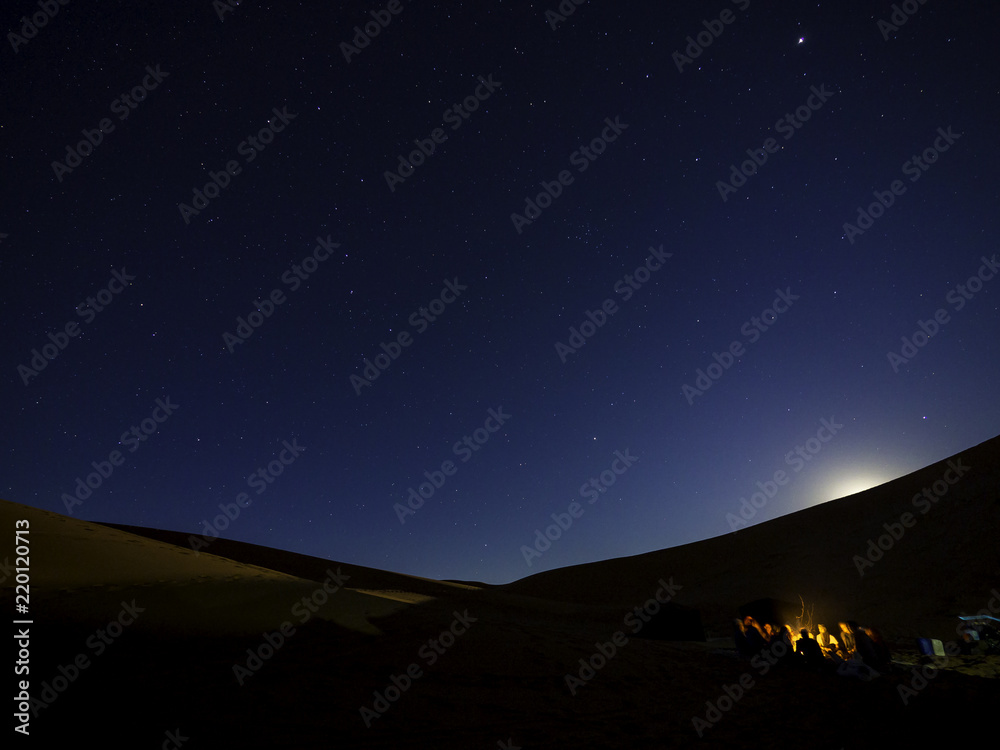 People camping under starry night in Sahara Desert