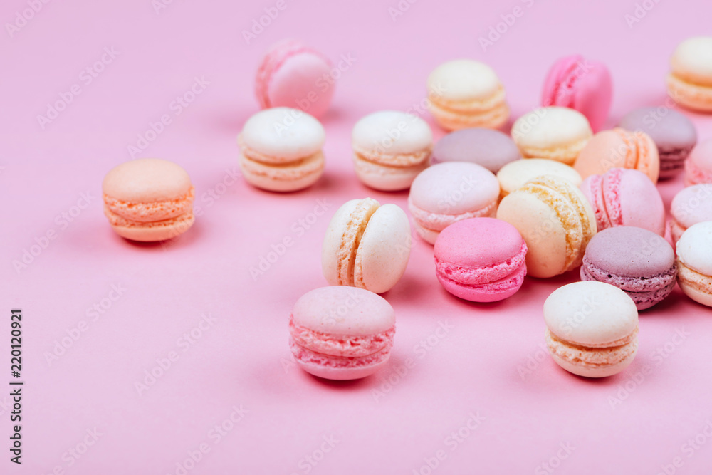 Group of sweet pink and white mini macarons on soft pink paper Group of sweet pink and white mini macarons on soft pink paper