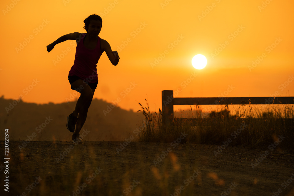 silhouette young fitness woman running sunset time