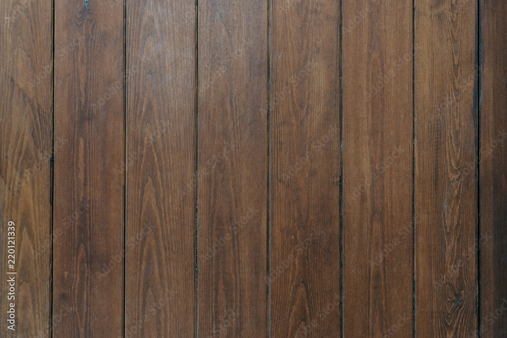 A few grungy ancient wooden planks in Spain. Wooden dark brown texture A few grungy ancient wooden planks in Spain. Wooden dark brown texture