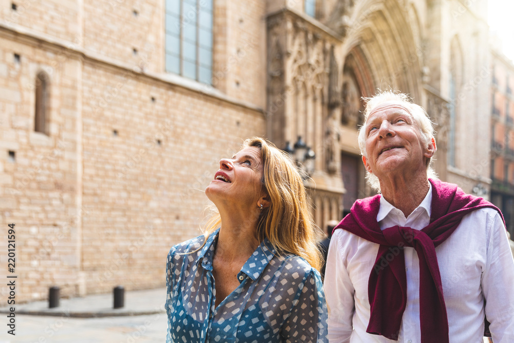 Senior couple of tourists visiting the old town in Barcelona - obrazy, fototapety, plakaty 