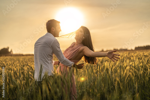 Romantic Couple Dancing on Love Moment at gold wheat flied 