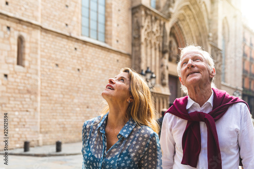 Senior couple of tourists visiting the old town in Barcelona photo