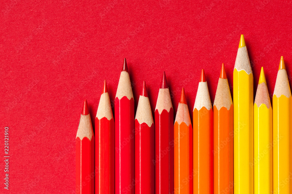 Color pencils isolated on red background.

