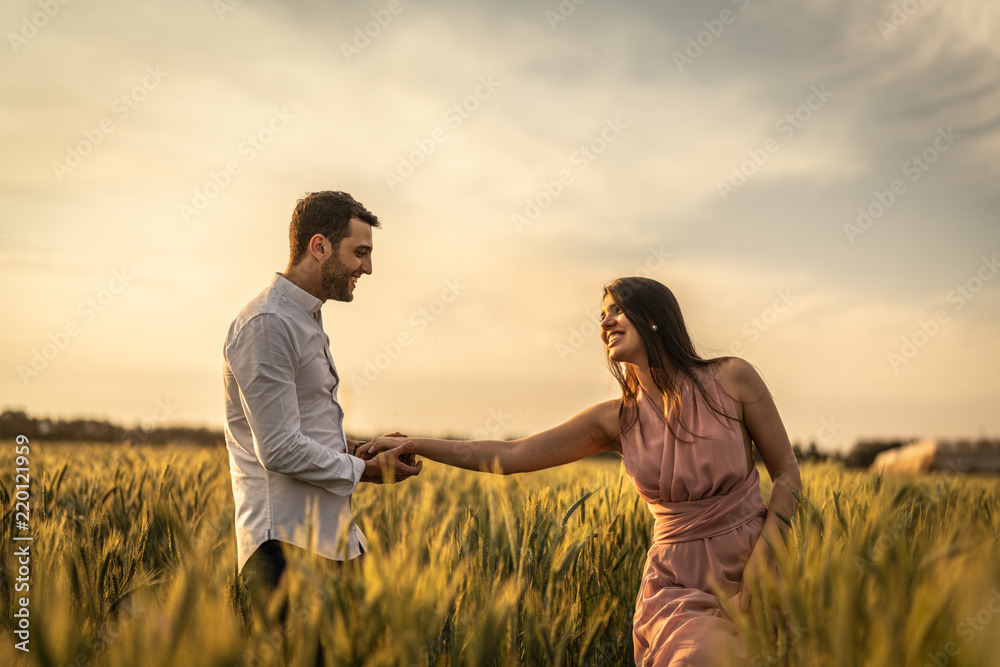 Romantic Couple on a Love Moment at gold wheat flied 