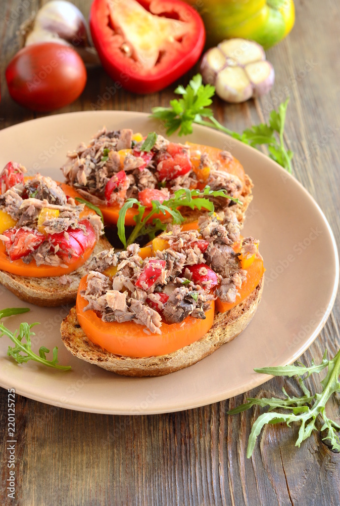 Bruschetta with tuna, tomatoes and sweet peppers, vertical