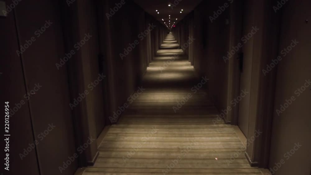 View down a long dark hotel hallway