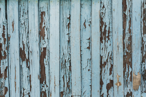 old wooden door with peeling and cracked white paint