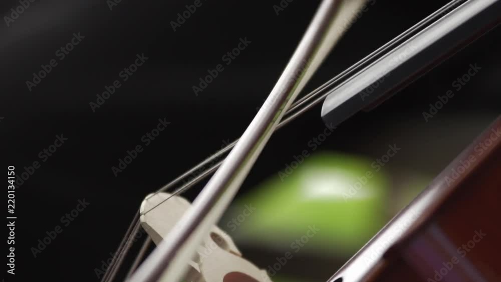 Extreme close up of a woman playing the cello, in slow motion Extreme close up of a woman playing the cello, in slow motion