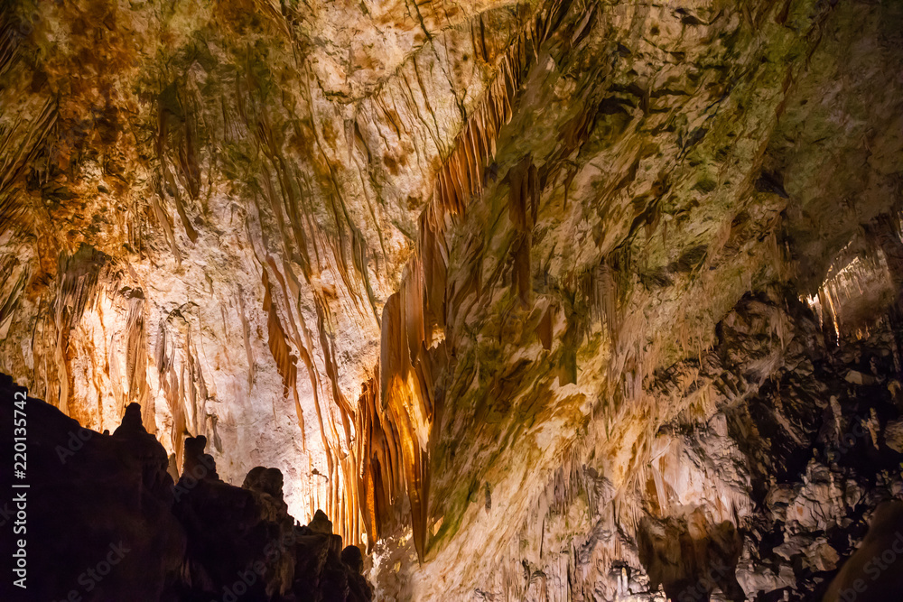 View of stalactites and stalagmites in an underground cavern - Postojna cave in Slovenia