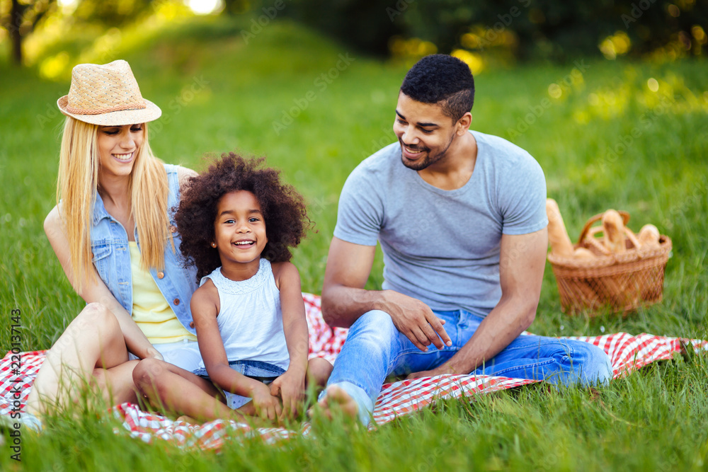 Picture of lovely couple with their daughter having picnic Picture of lovely couple with their daughter having picnic