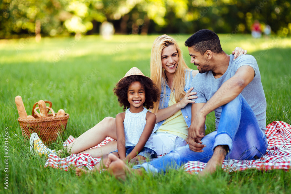 Picture of lovely couple with their daughter having picnic Picture of lovely couple with their daughter having picnic