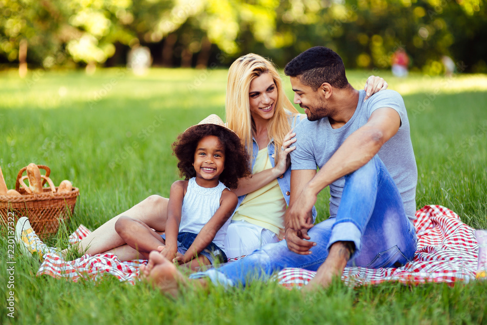 Picture of lovely couple with their daughter having picnic