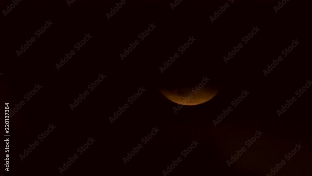 Orange Full moon transit from horizon in a cloudy sky timelapse Orange Full moon transit from horizon in a cloudy sky timelapse
