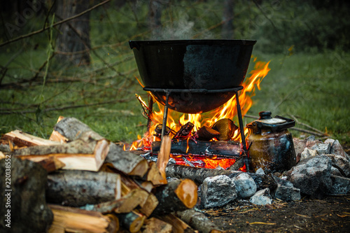 a cauldron for cooking is on the fire