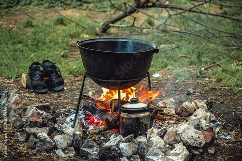 a cauldron for cooking is on the fire
