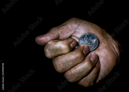 Indonesia rupiah coin in the hand of an asian person isolated. Concept of stealing the money.