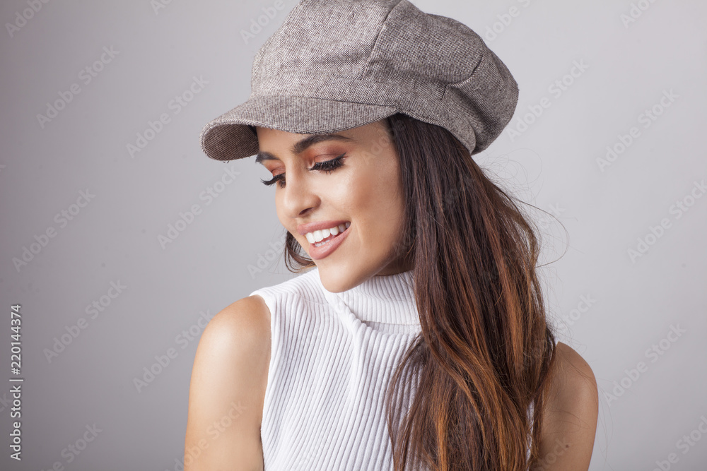 Beautiful brunette in the hat in front of camera. Beautiful brunette in the hat in front of camera.