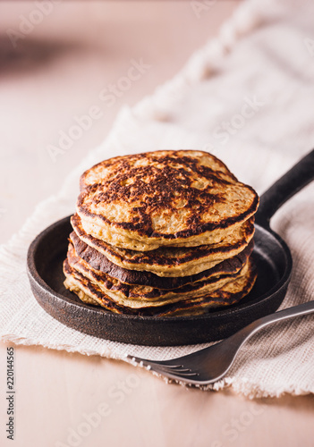 Pile of homemade pancakes freshly made on a small pan