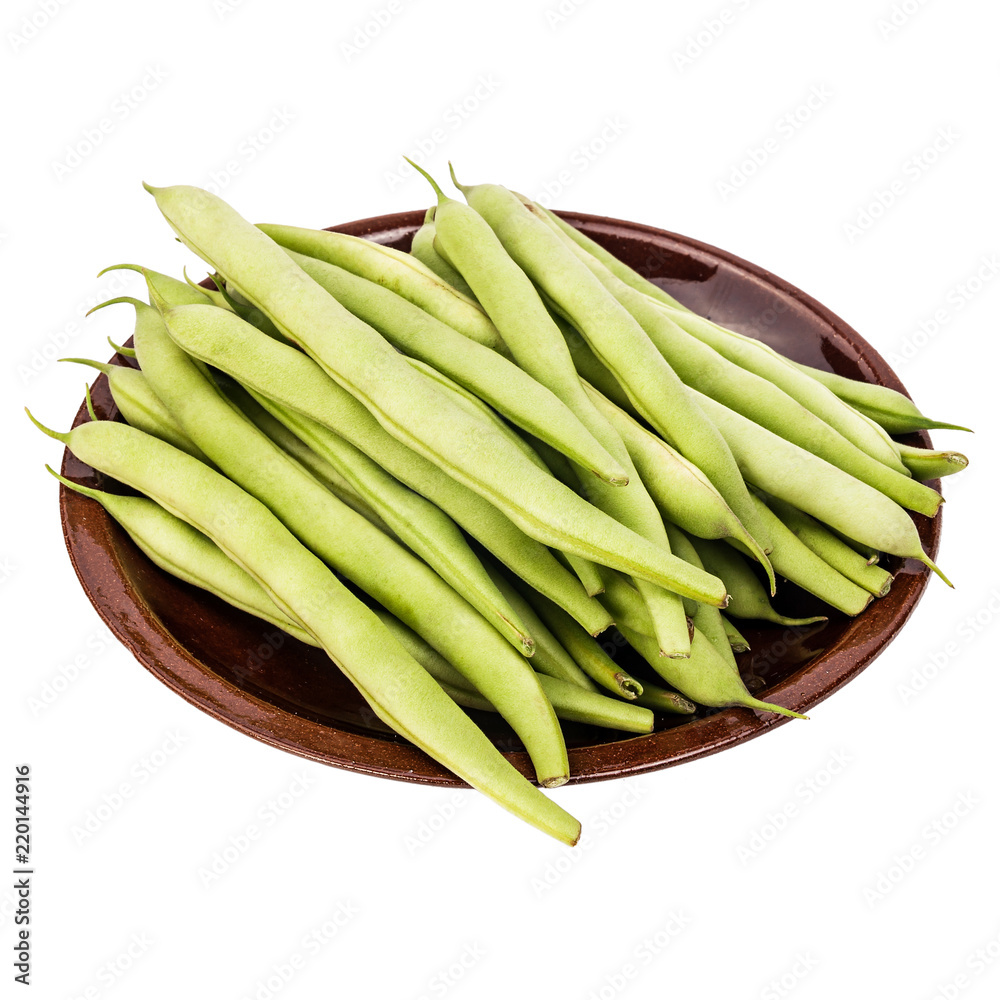 Fresh green beans in a clay plate on a table, white isolated background Fresh green beans in a clay plate on a table, white isolated background