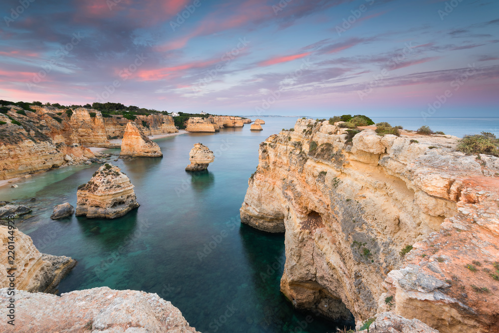 Amazing sunset at Marinha Beach in the Algarve, Portugal. Landscape with strong colors of one of the main holiday destinations in europe. Summer tourist attraction.