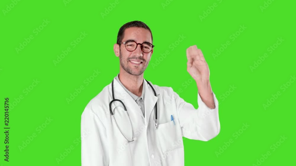 Happy young doctor greeting against green background Happy young doctor greeting against green background