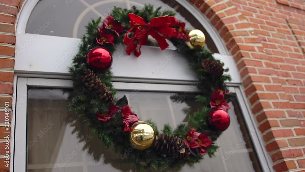 Snow falling on an outdoor Christmas wreath in slow motion Snow falling on an outdoor Christmas wreath in slow motion